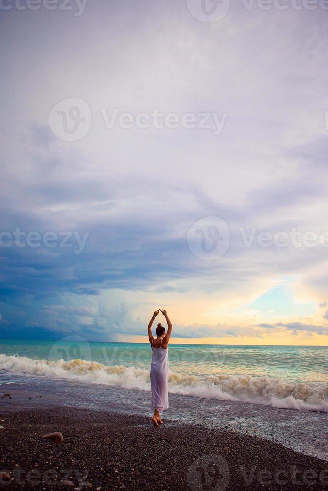 Woman on the beach enjoying summer holidays photo