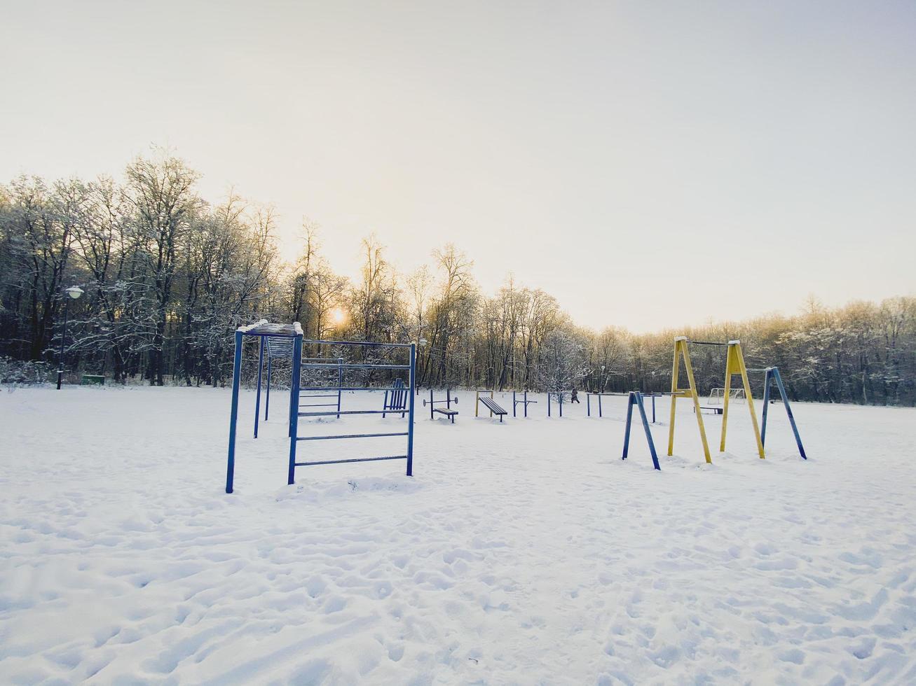 Winter sunset in snow covered park. Season and cold weather concept photo