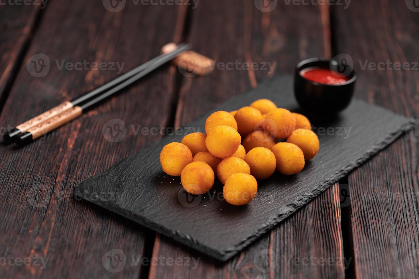 fish balls in batter with chopsticks - asian food top view photo