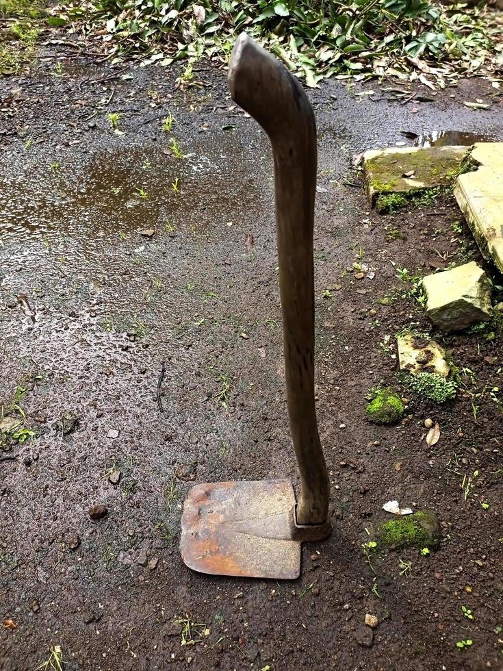 Farmer's old hoe lying on the ground photo