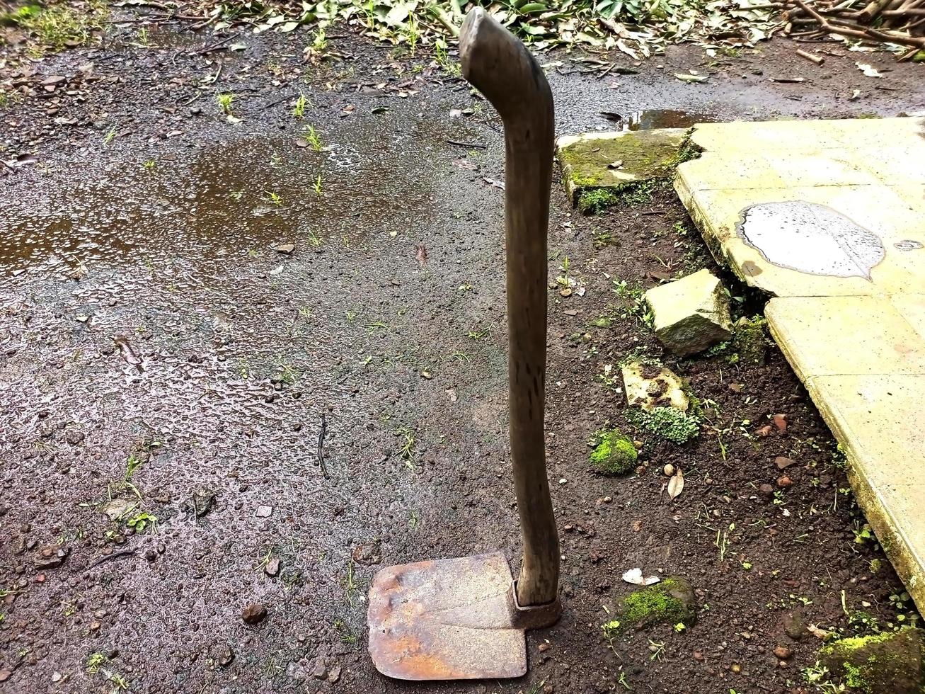 Farmer's old hoe lying on the ground photo