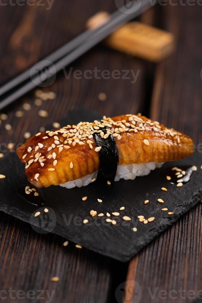 Japanese sushi unagi nigiri sushi smoked eel on wooden background close-up photo