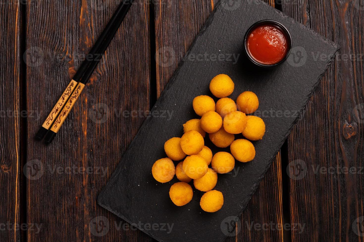 fish balls in batter with chopsticks - asian food top view photo