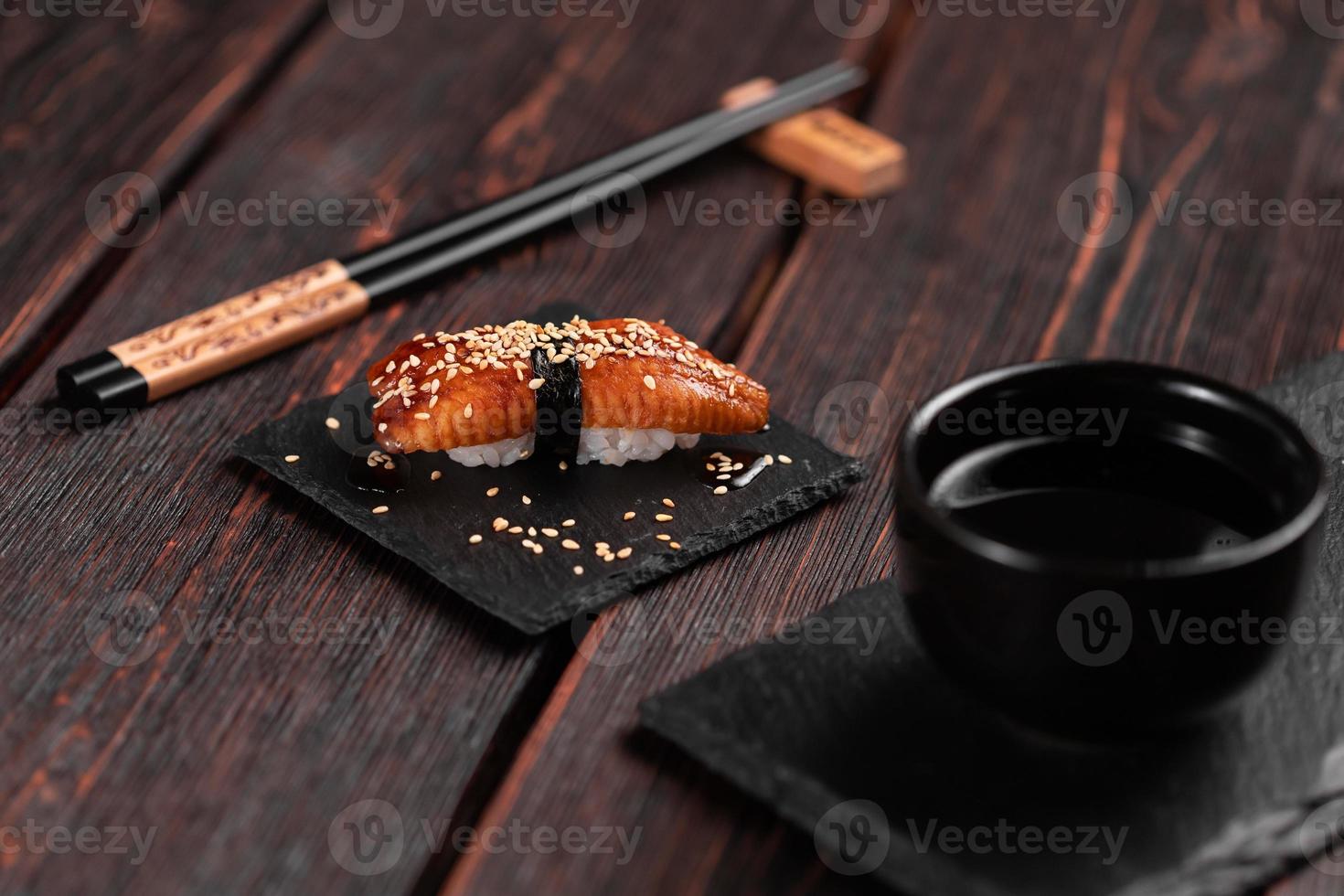 Japanese sushi unagi nigiri sushi smoked eel on wooden background close-up photo