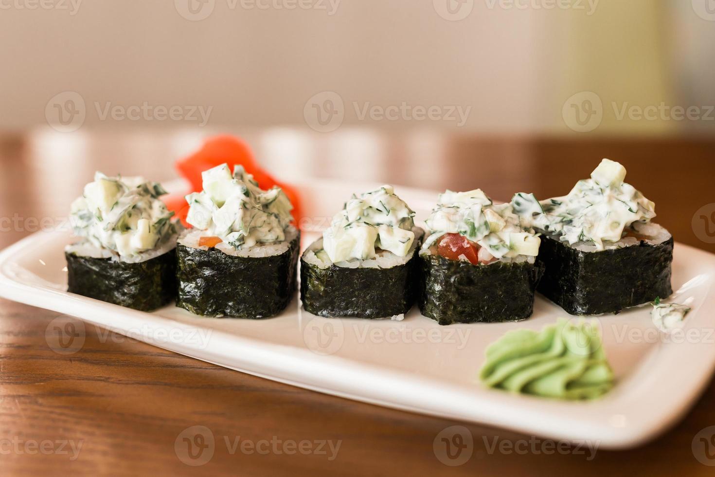 Traditional delicious fresh sushi roll set on a plate in restaurant. Sushi menu. Japanese kitchen, restaurant. photo