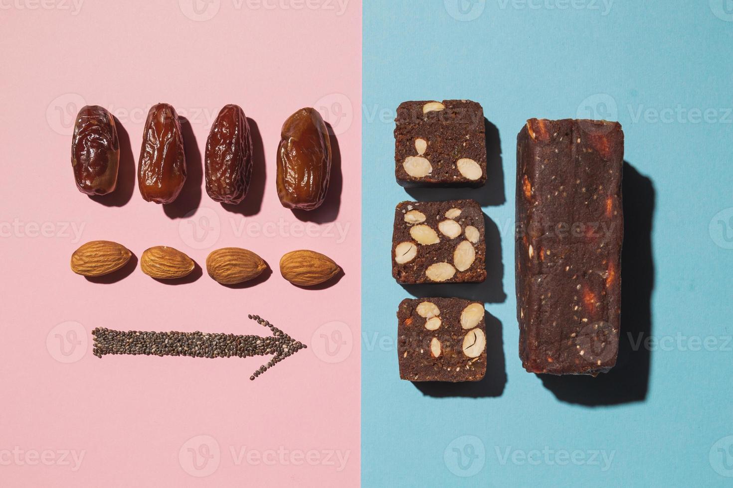 Protein date fruit candy bars fitness with nuts and fruit almond and chia poppy seeds top view on blue pink background with copy space and place for text photo