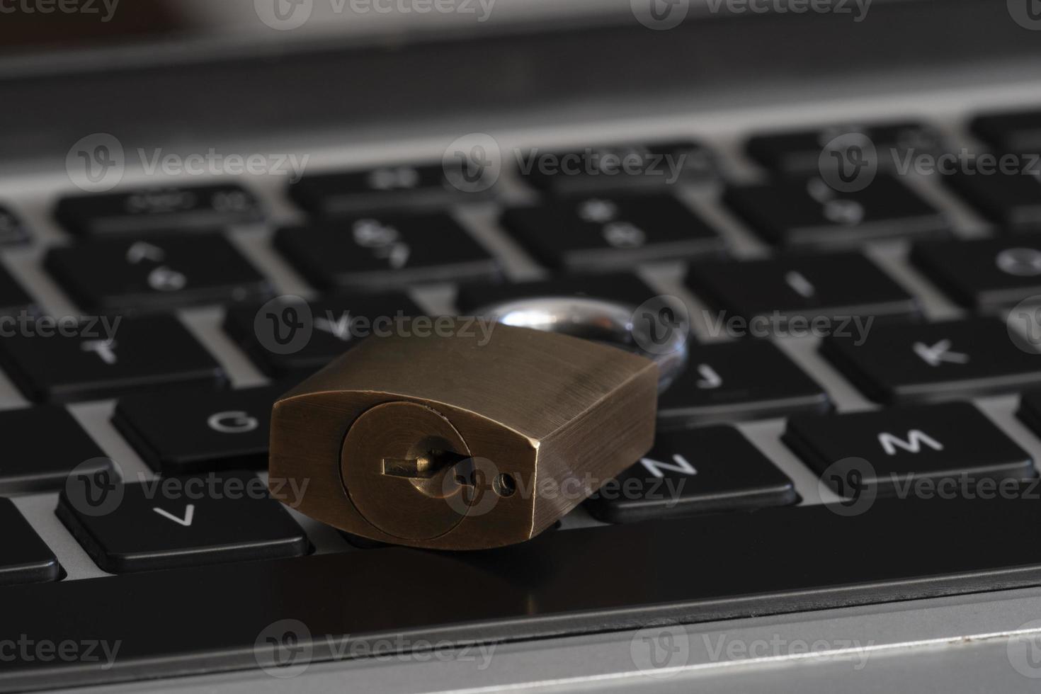 internet and computer security represented by a closed padlock over a black keyboard photo