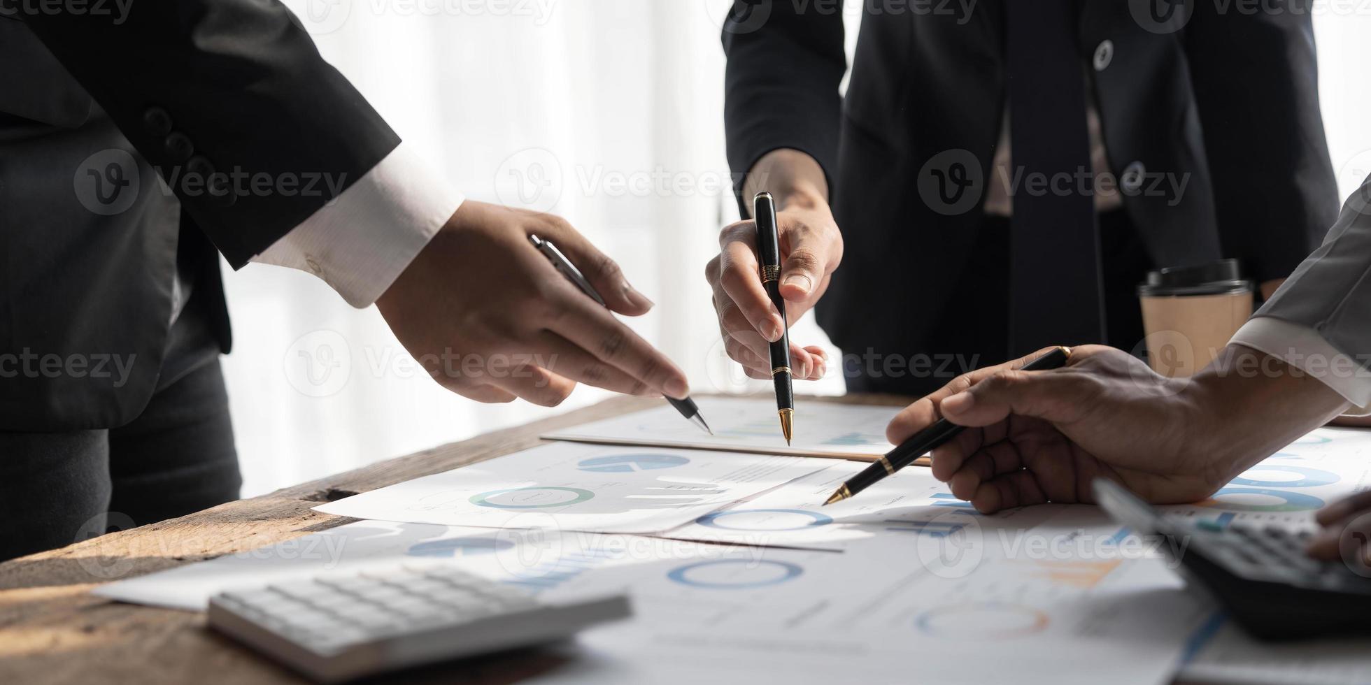 Business People Meeting using laptop computer,calculator,notebook,stock market chart paper for analysis Plans to improve quality next month. Conference Discussion Corporate Concept photo