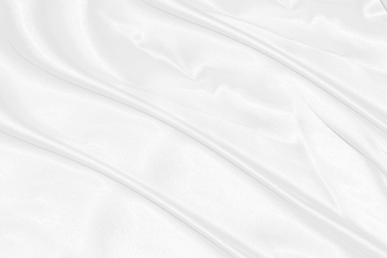 white silk textured cloth background,Closeup of rippled satin fabric with soft waves. photo
