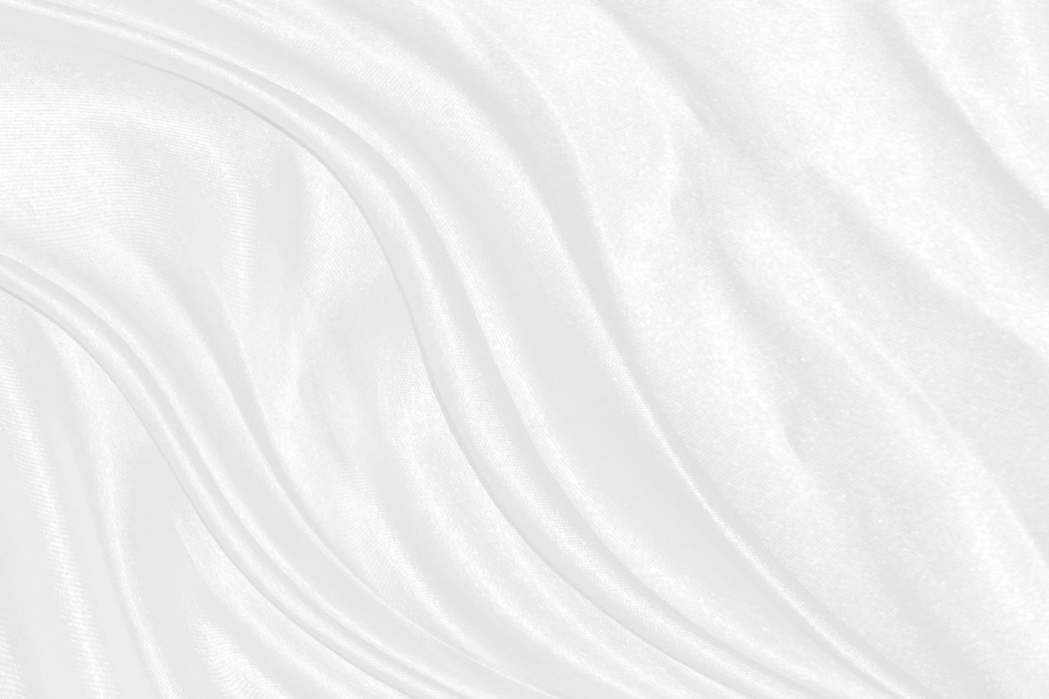 Smooth elegant white silk or satin luxury cloth texture can use as wedding background. Luxurious background design photo