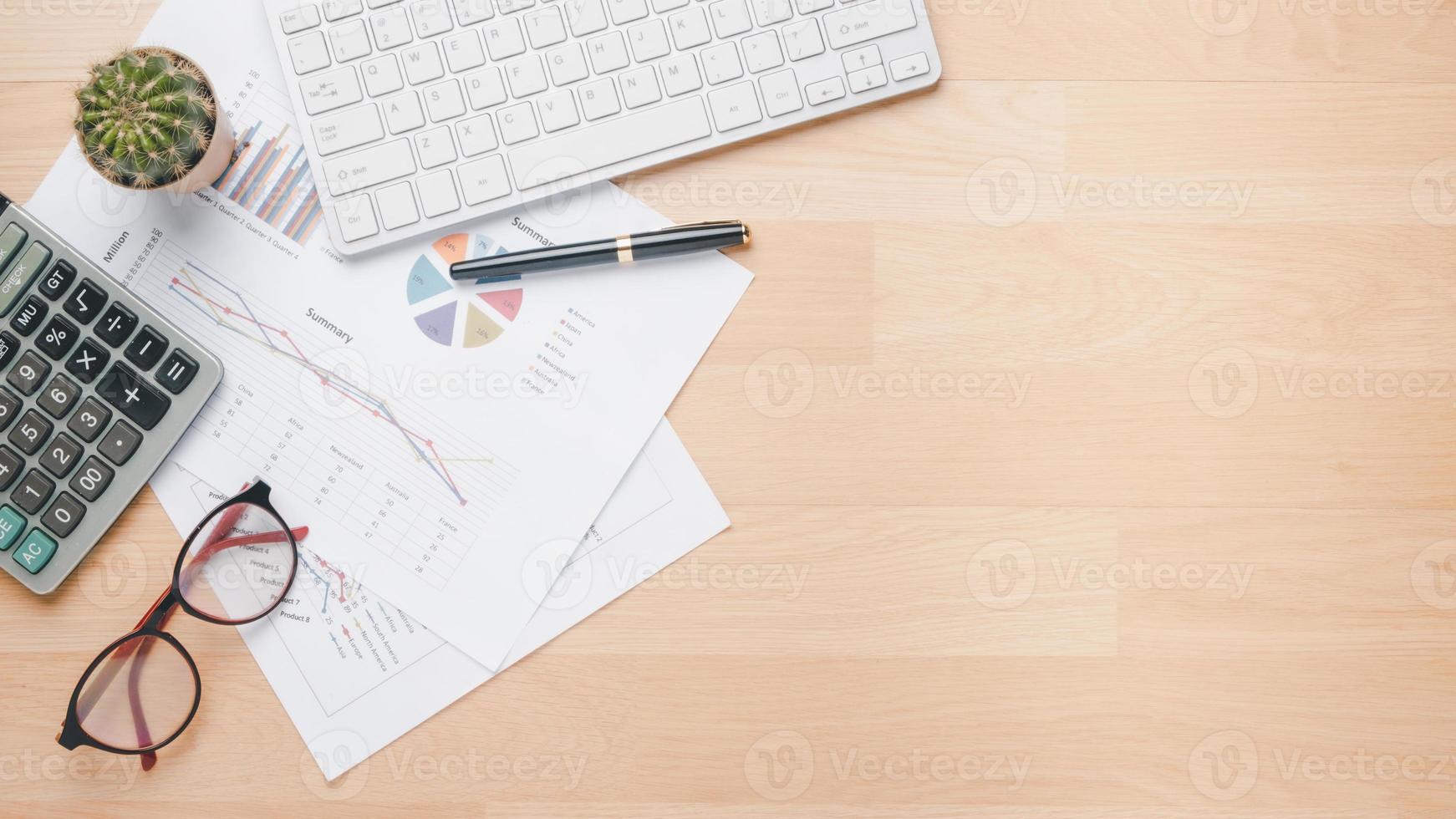 Business charts and reports on office desk workplace. Top view flat lay photo