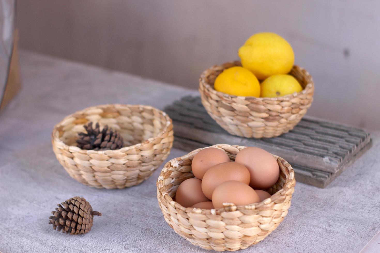 antique ethnic woven bowl with lemon and eggs photo