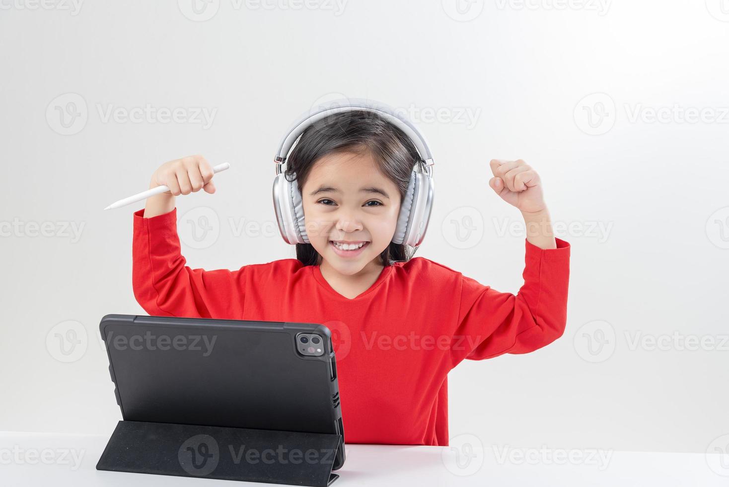 little girl asia cute put on headphones have video call distant class with teacher using laptop,  study online on computer, homeschooling concept photo