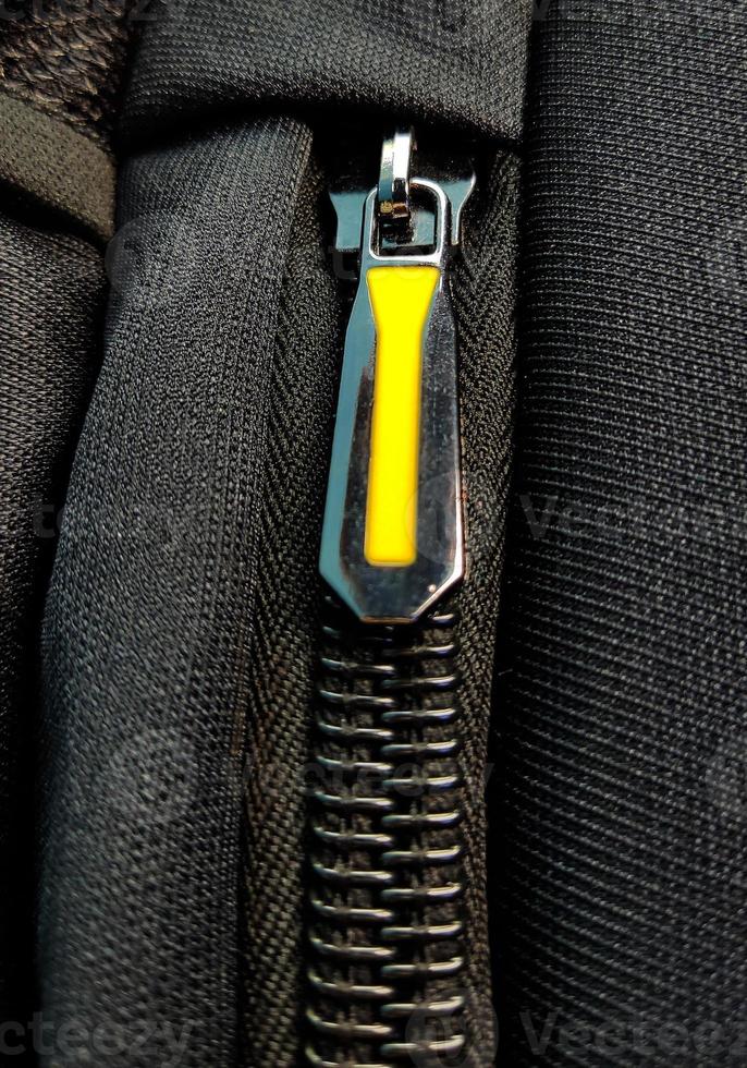 A closeup shot of the zipper on the luxury black bag photo