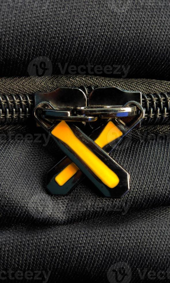 A closeup shot of the zipper on the luxury black bag photo