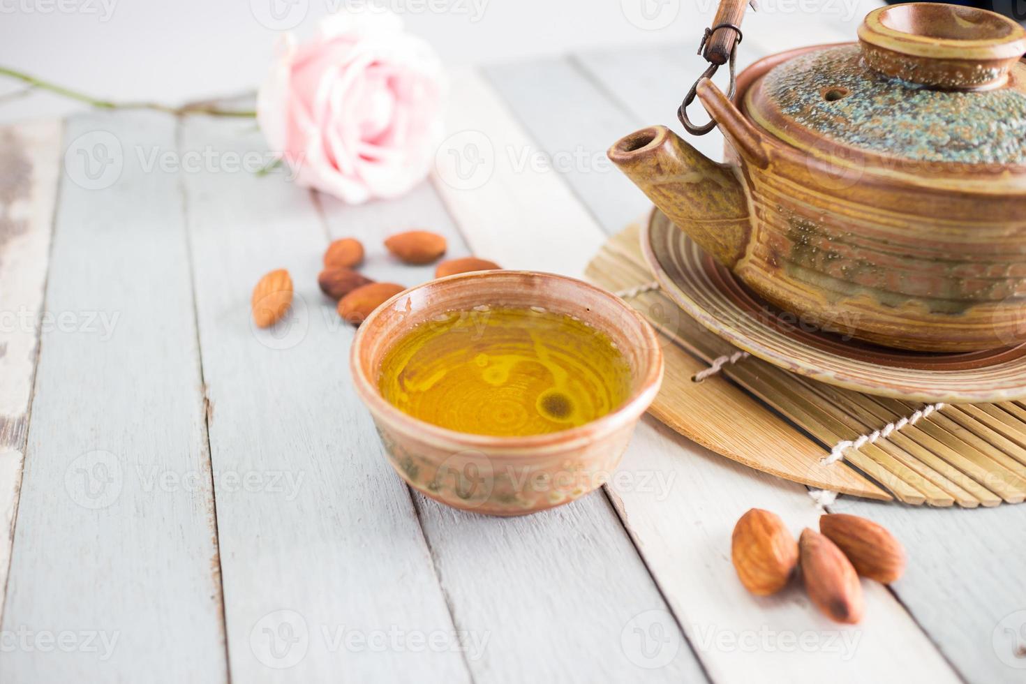 tea set and almon nut on old wood background photo