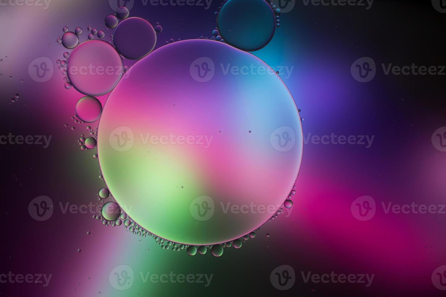 Colorful artistic of oil drop floating on the water photo