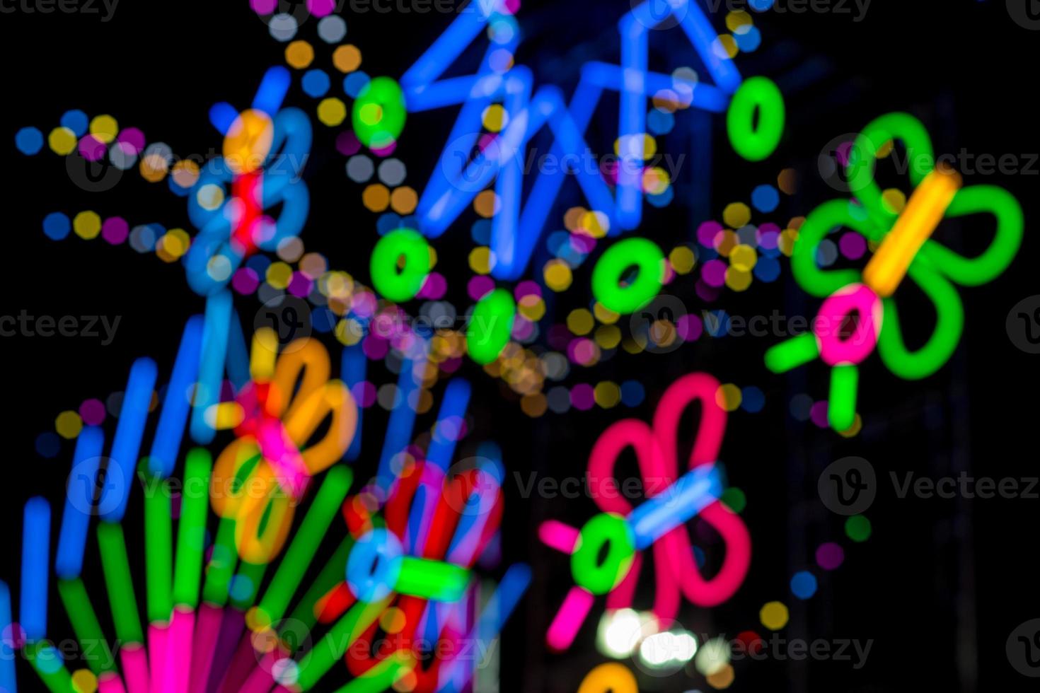 Blured Multi-colored neon lights at night. photo