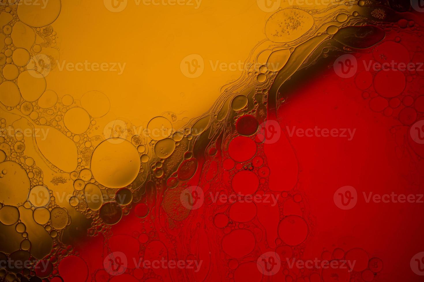 Top view movement of bubbles in the liquid. Oil surface multicolored background. Fantastic structure of colorful bubbles. Colorful artistic image of oil drop floating on the water. photo
