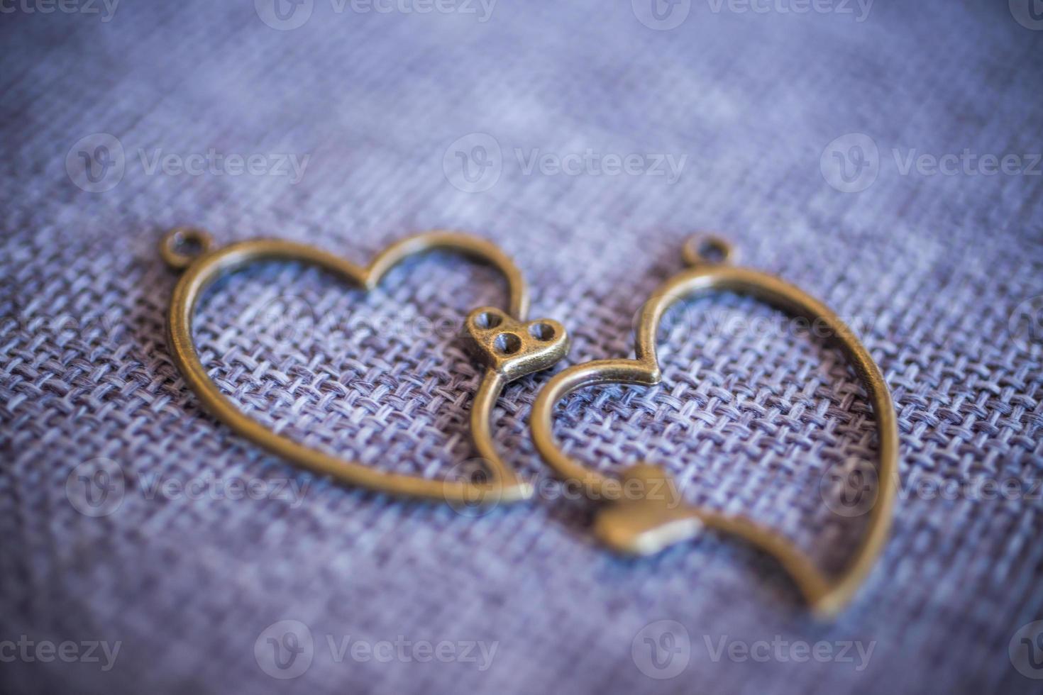 Heart pendant on old fabric, texture background, valentine concept photo