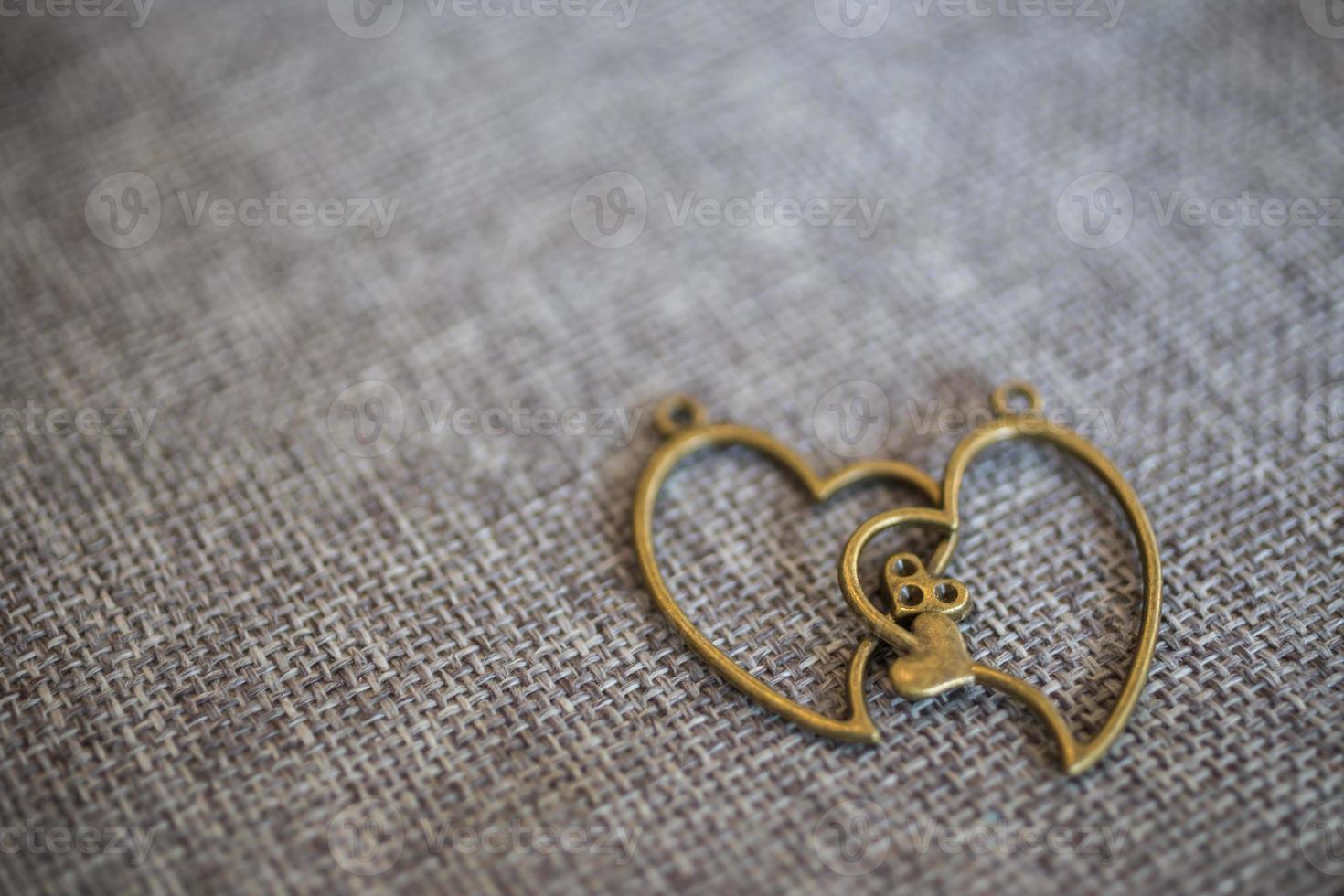 Heart pendant on old fabric, texture background, valentine concept photo