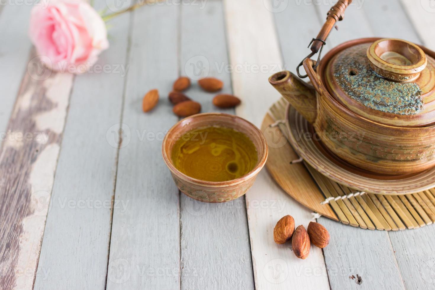 tea set and almon nut on old wood background photo