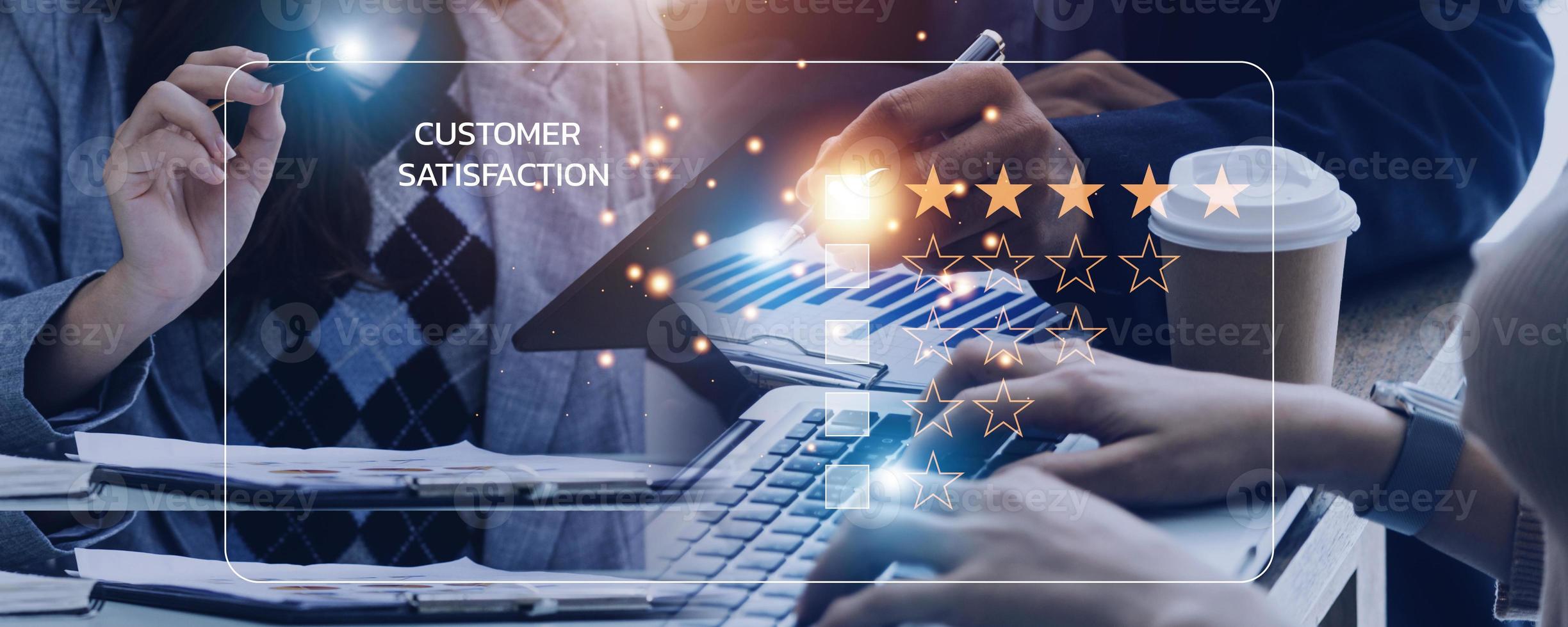 close up Man hand using computer Notebook with popup five star icon for feedback review satisfaction service, Customer service experience and business satisfaction survey. photo