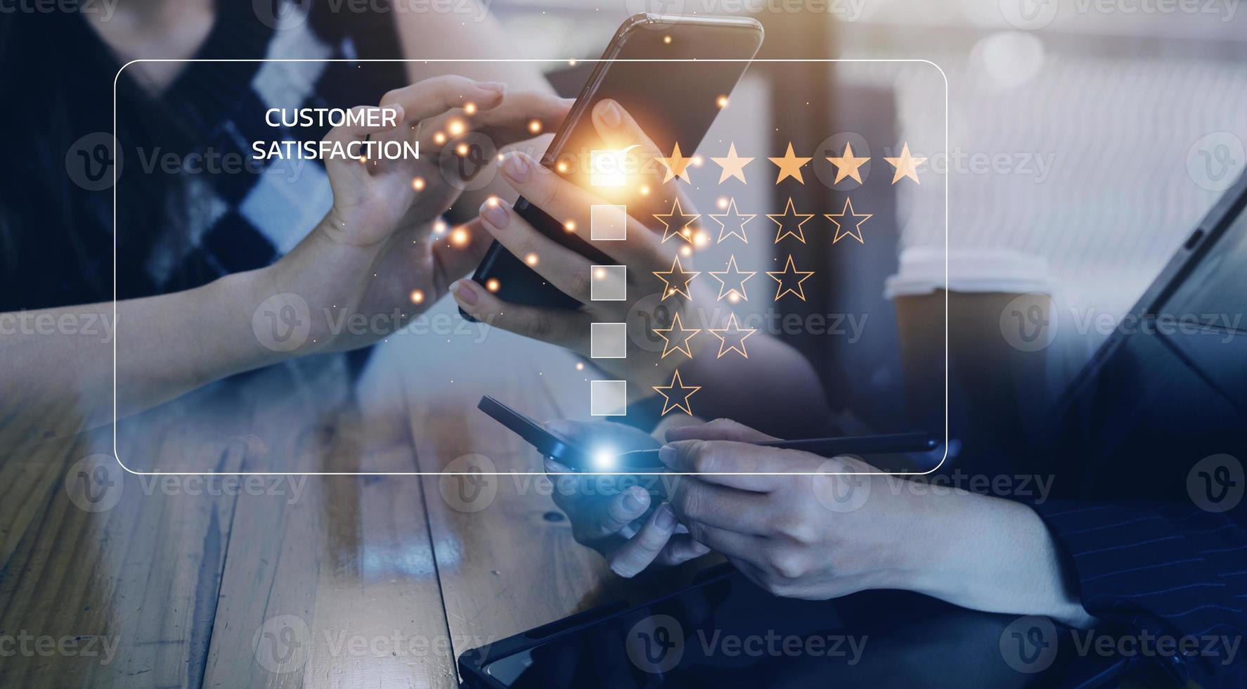close up Man hand using computer Notebook with popup five star icon for feedback review satisfaction service, Customer service experience and business satisfaction survey. photo