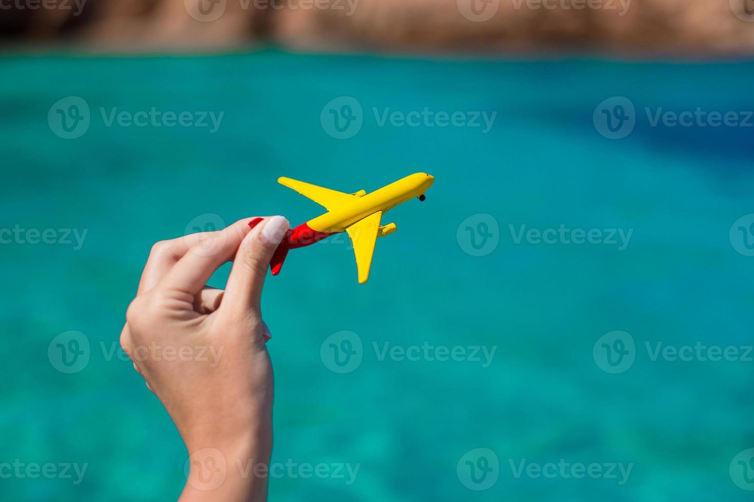 Small homemade plane on background of turquoise sea photo