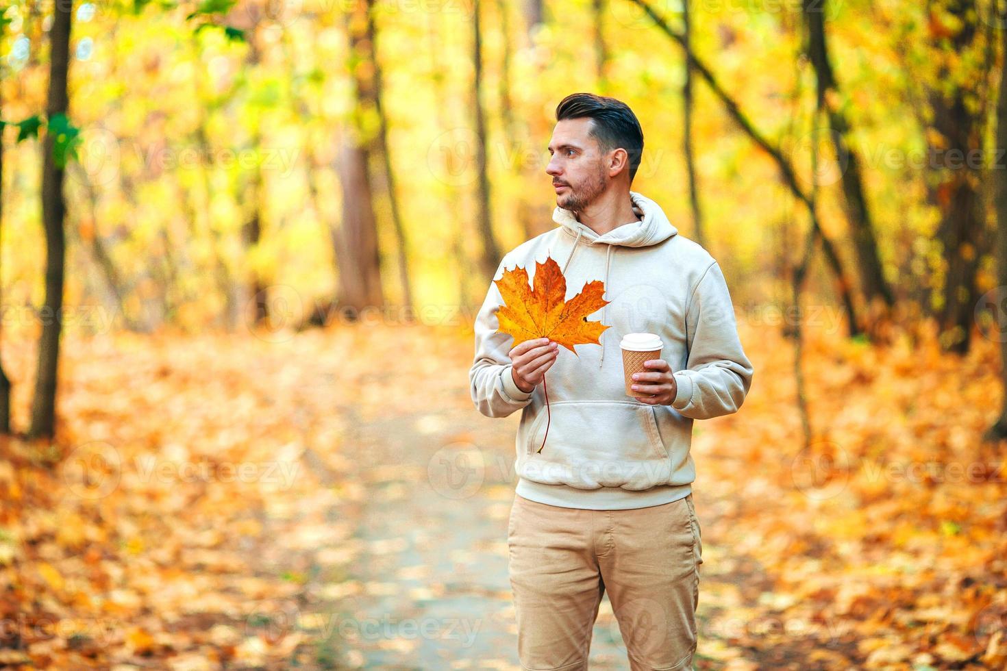 Young man in autumn park outdoors photo