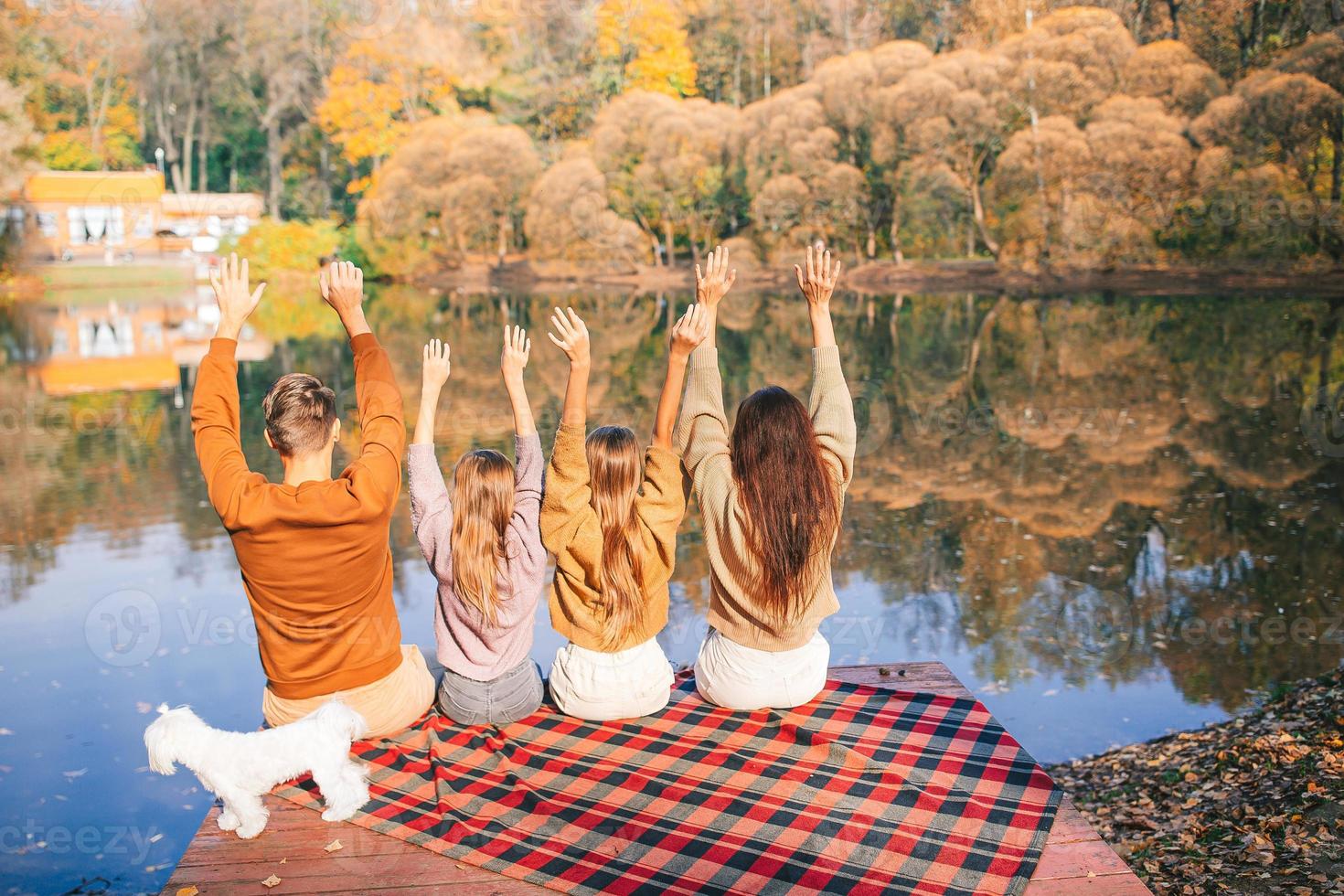 Beautiful family at autumn warm day near lake photo