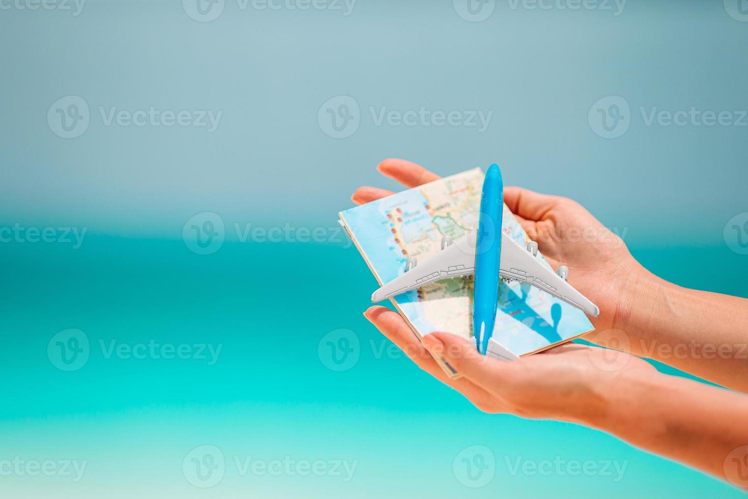 Closeup of map and model airplane background the sea photo