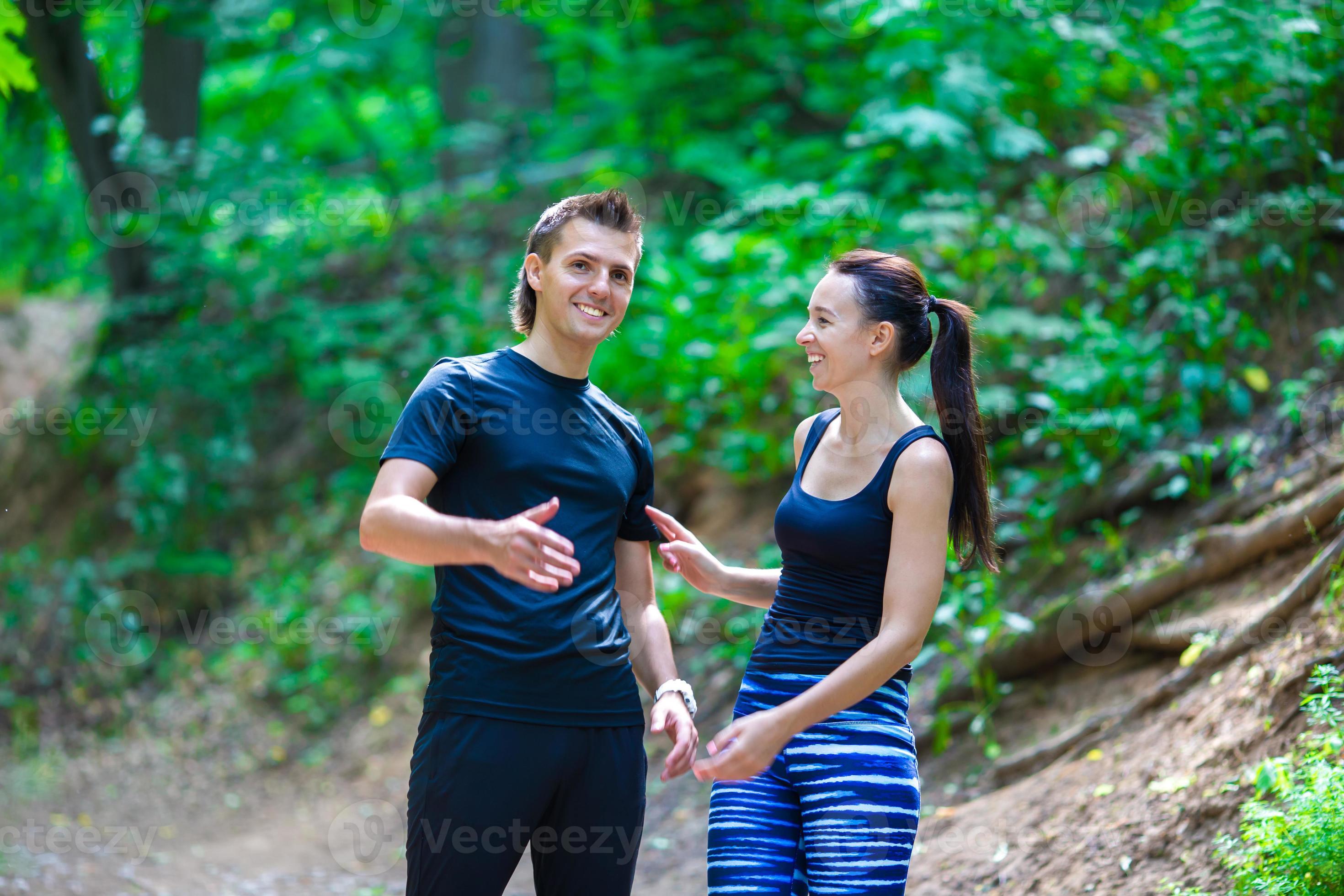 Jogging active couple resting after running outdoors in forest 18018328