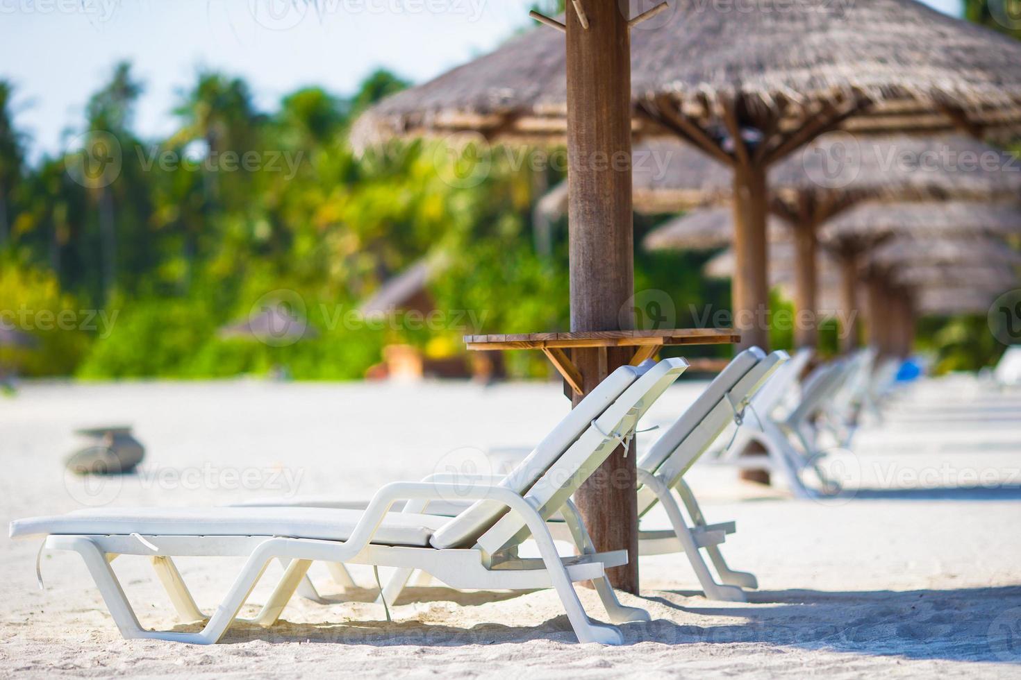 Beach wooden chairs for vacations on tropical beach photo