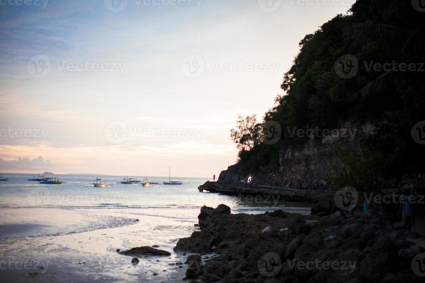 Tropical beach at sunset on an exotic island photo