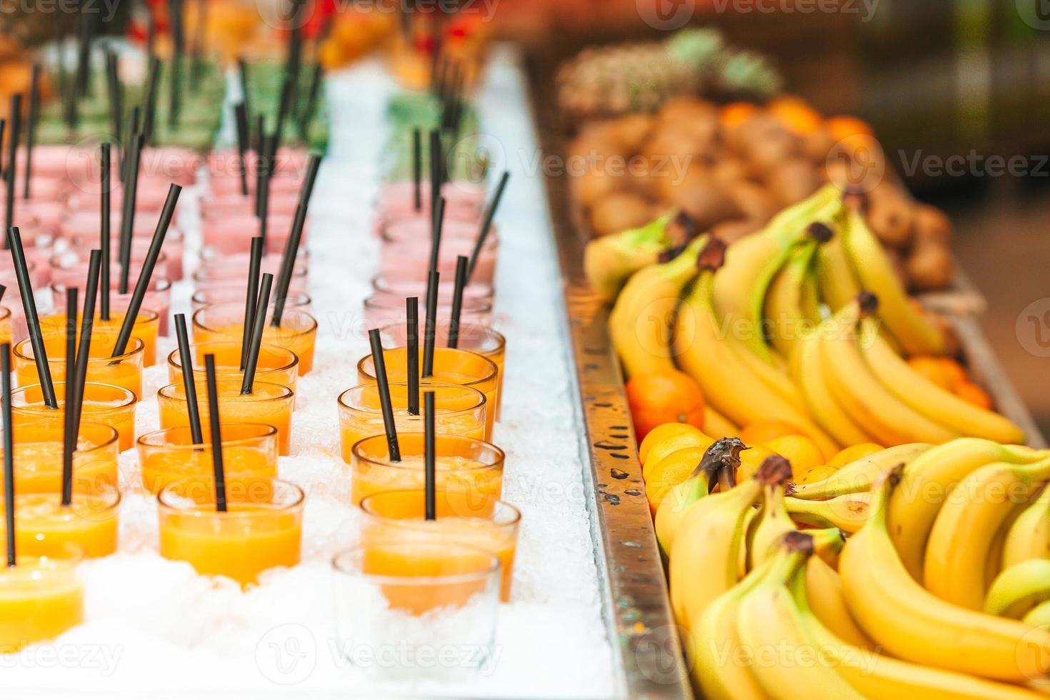 Row of healthy fresh fruit and vegetable smoothies with assorted ingredients. photo