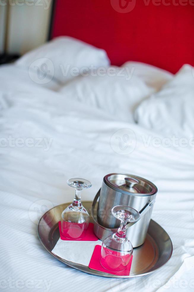 Romantic bedroom with wine glasses in luxury hotel interior photo