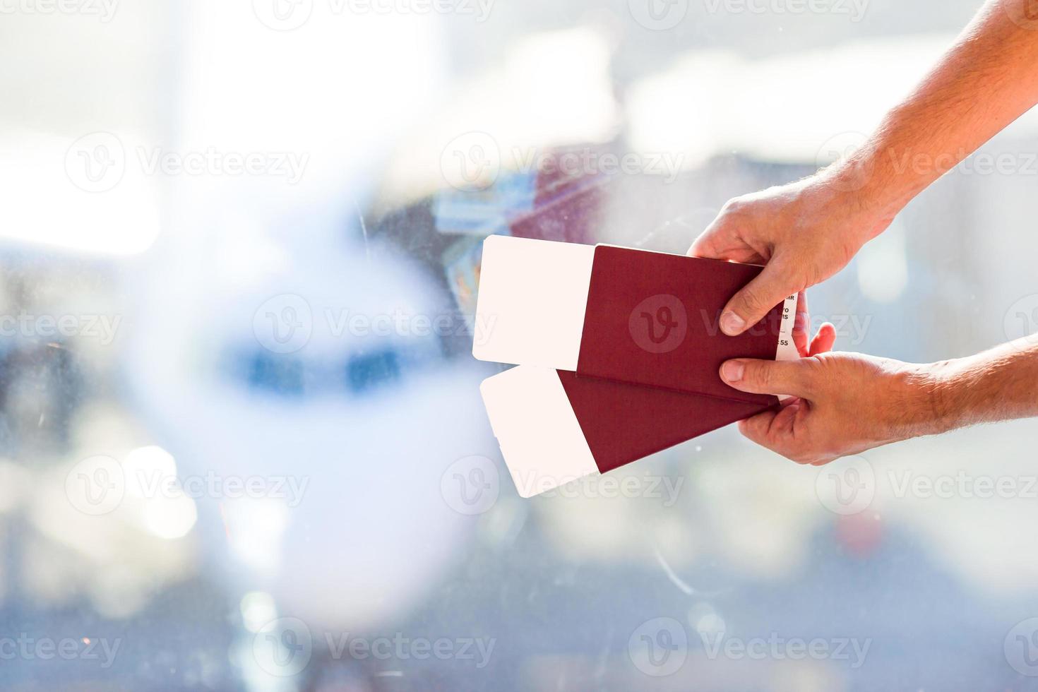 Closeup passports and boarding pass at airport indoor background airplane photo