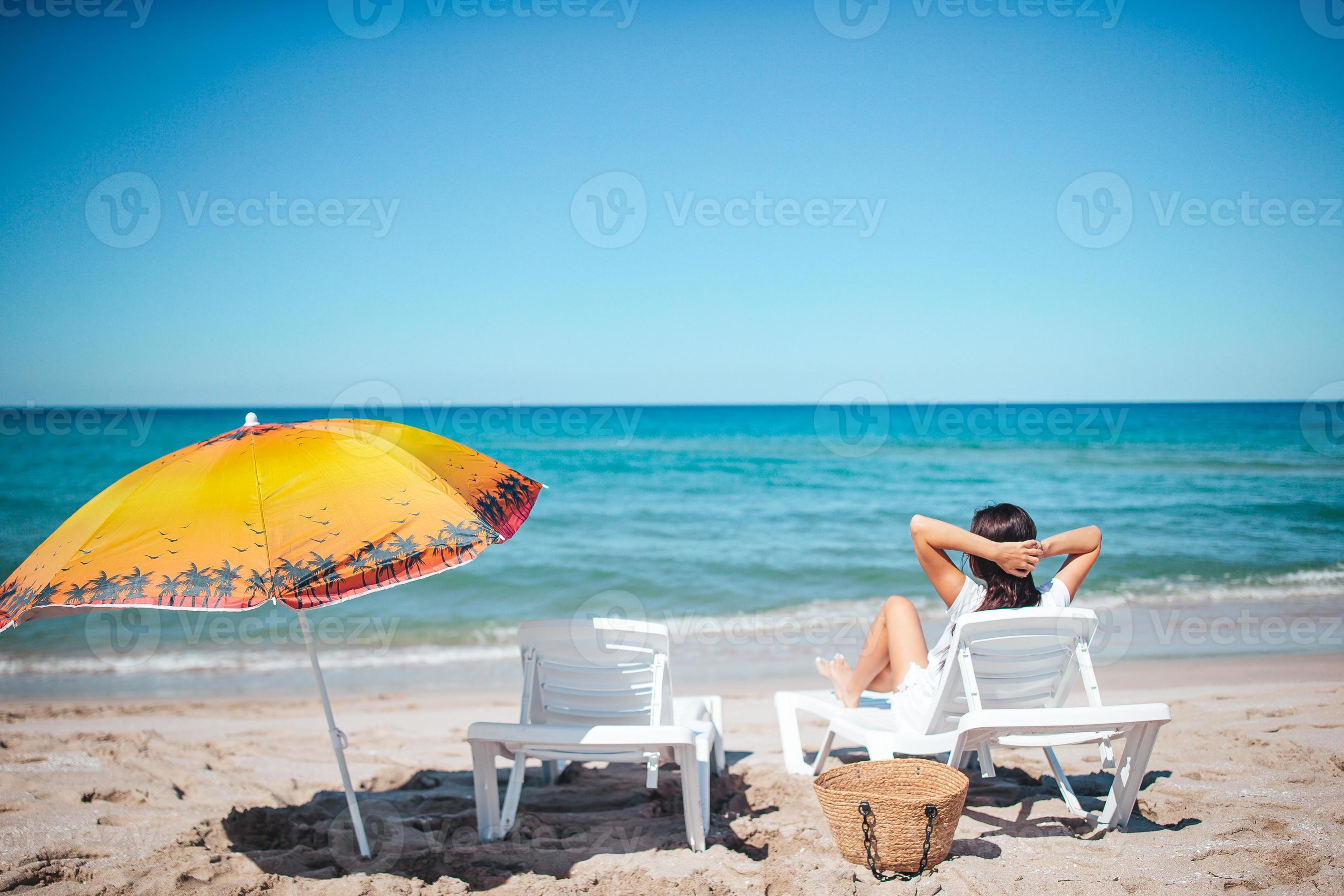 Young happy woman on the beach relaxing on the sun bed 18036213 Stock