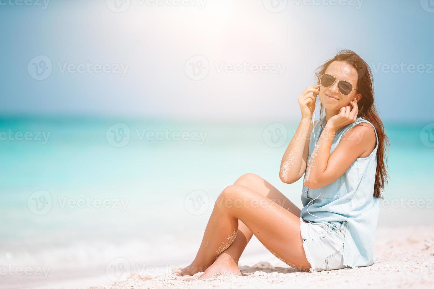 Young fashion woman in green dress on the beach photo