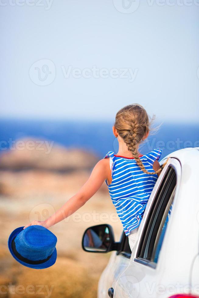 Little girl on vacation travel by car background beautiful landscape photo