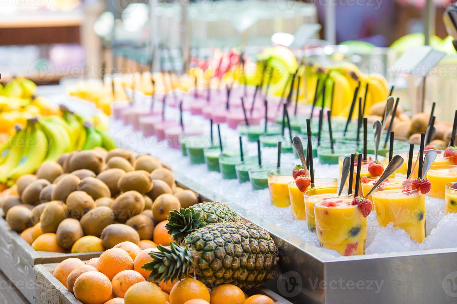 Delicious sweet cocktails and fresh fruits in the shop with takeaway photo