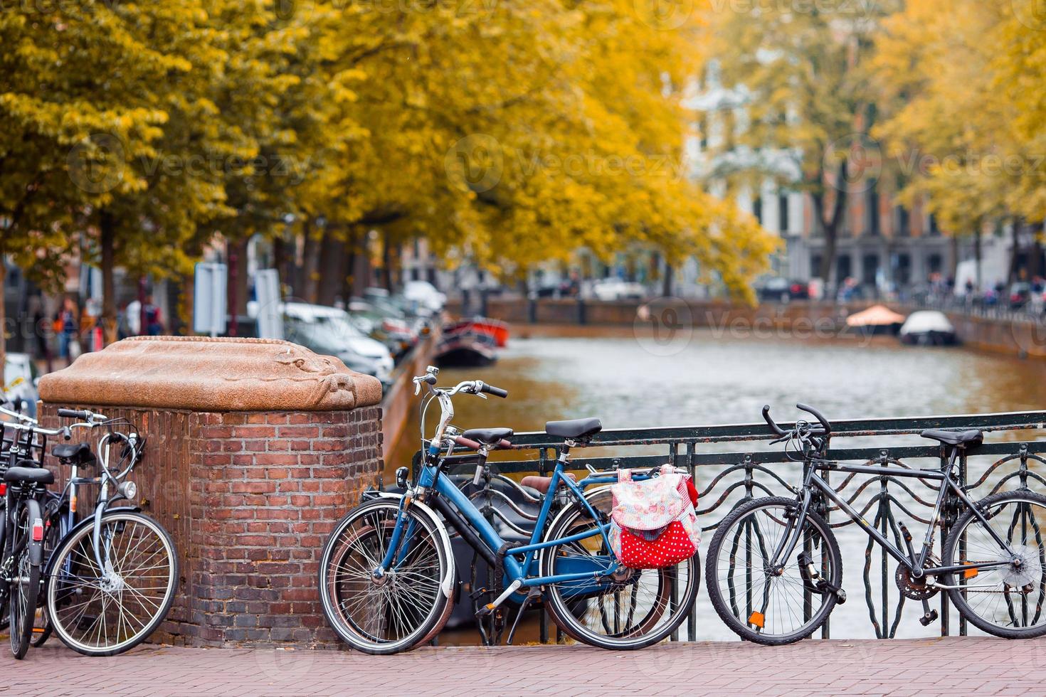 Bike on the bridge in Amsterdam, Netherlands. Beautiful view of canals in autumn photo