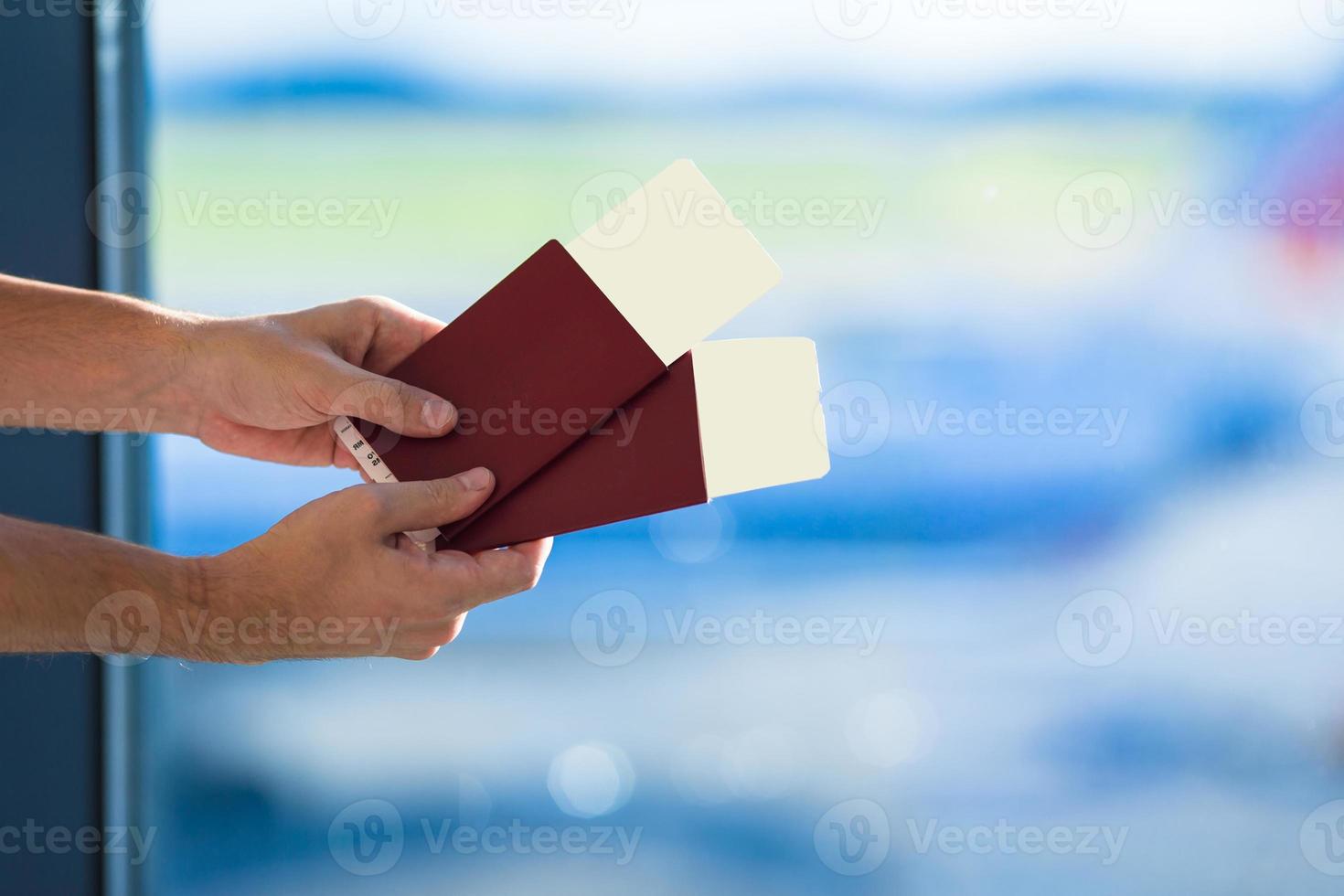 Closeup passports and boarding pass at airport indoor background airplane photo