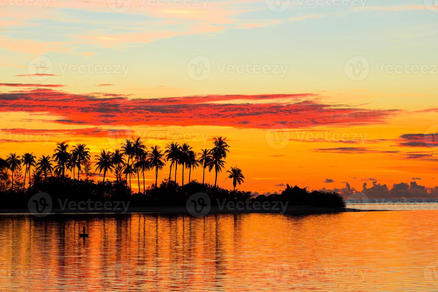 Beautiful sunset with dark silhouettes of palm trees and amazing cloudy sky in Indian island photo