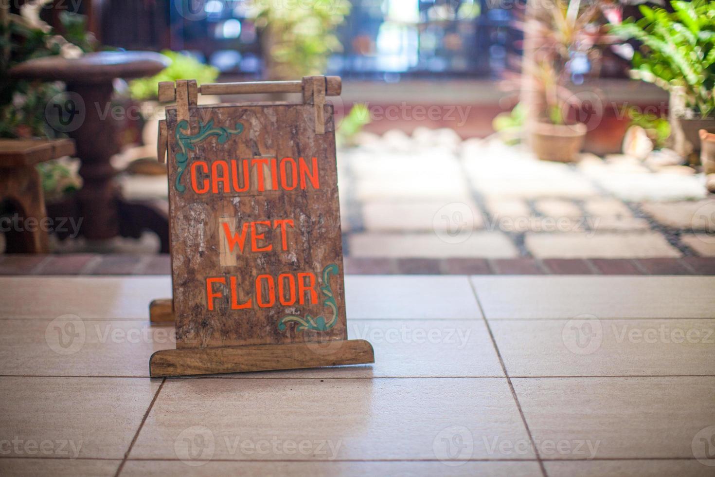 Sign at the small hotel-wet floor caution photo