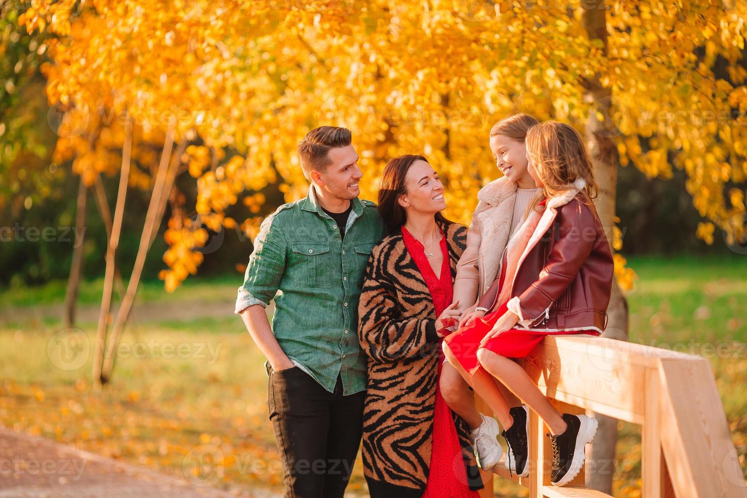 Portrait of happy family of four in autumn photo