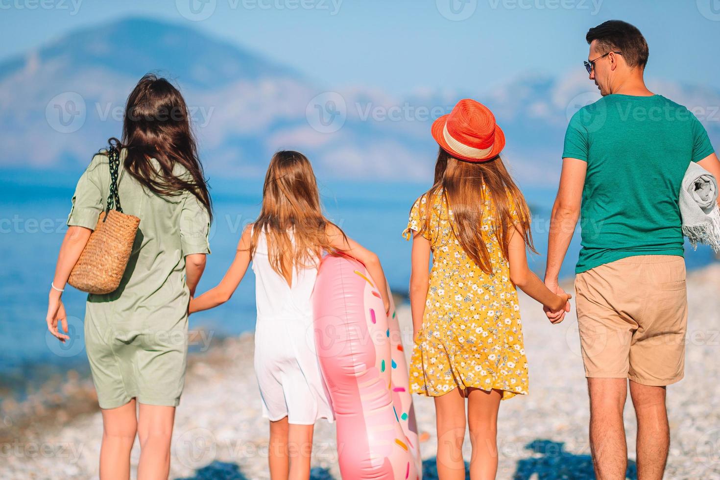 Photo of happy family having fun on the beach. Summer Lifestyle