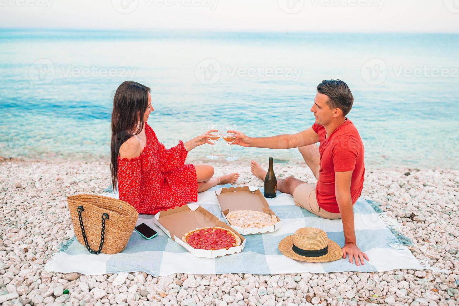 Family having a picnic on the beach photo