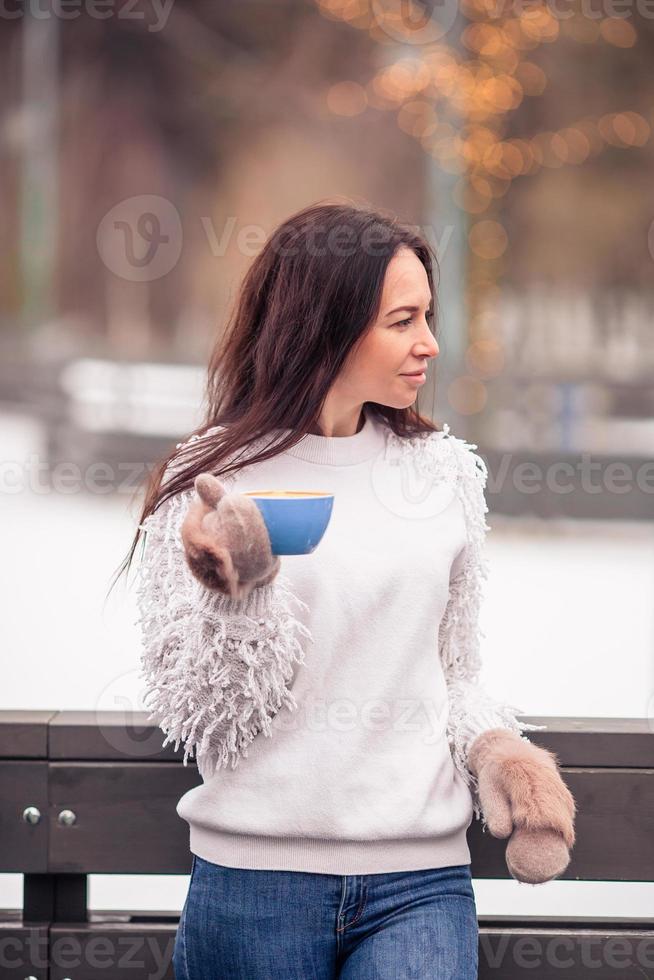 Smiling young girl skating on ice rink outdoors photo